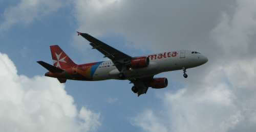 AirMalta plane flying over Malta International Airport