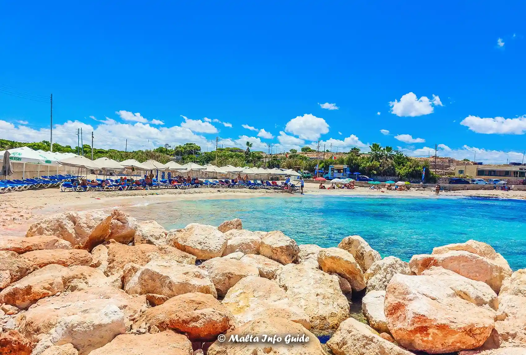 Rocky Armier shoreline beside clear blue Mediterranean water.
