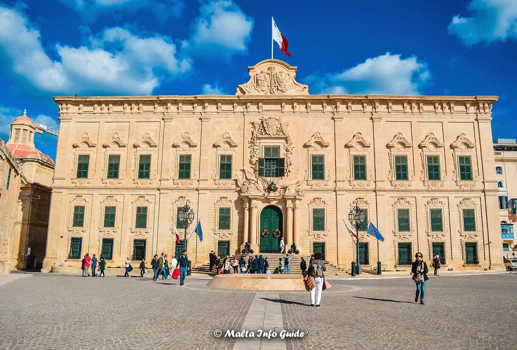Tourists observing the Auberge de Castille, Valletta, Malta.