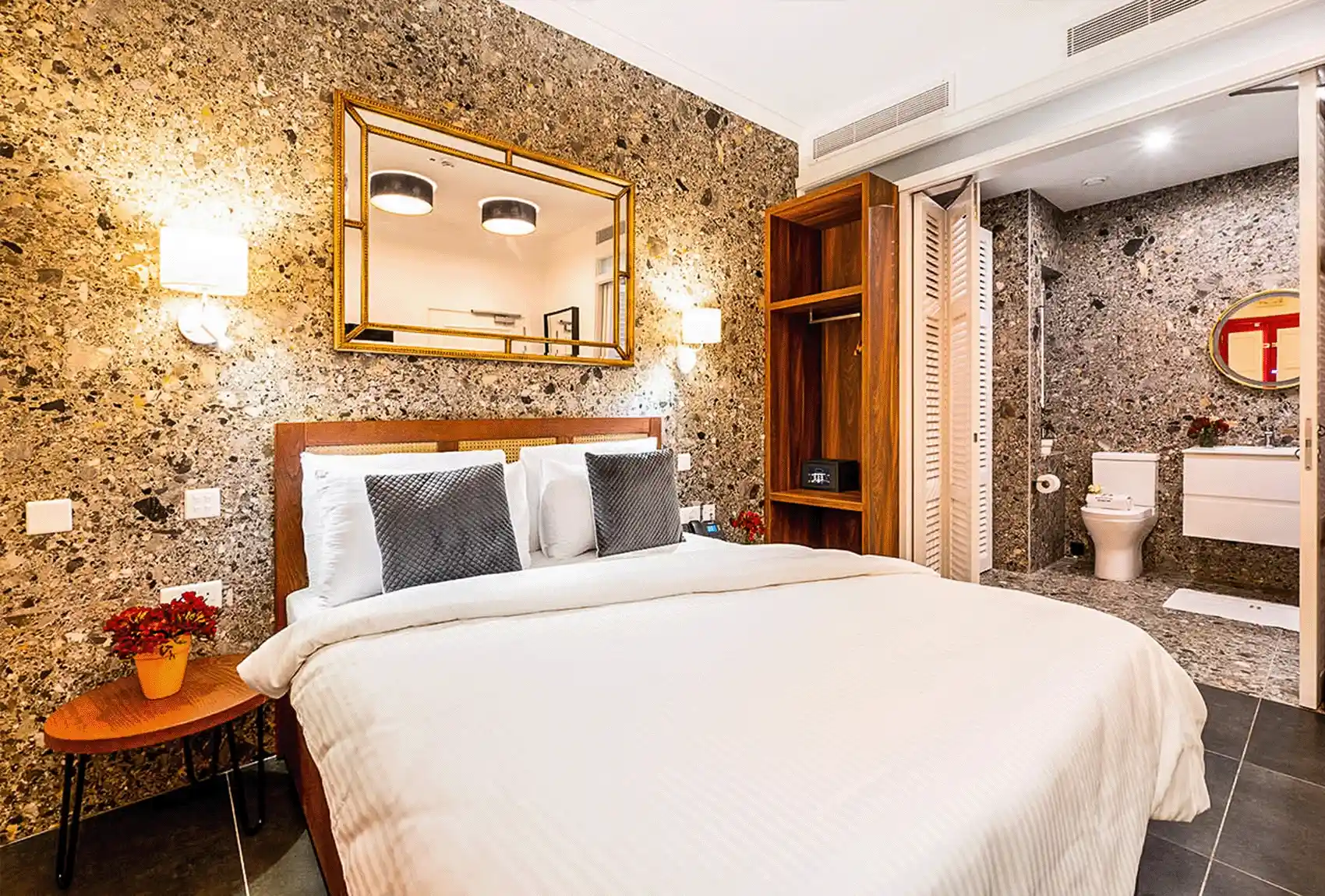 Elegant double room with wooden furniture in Battistini Boutique Victoria, Gozo, Malta.