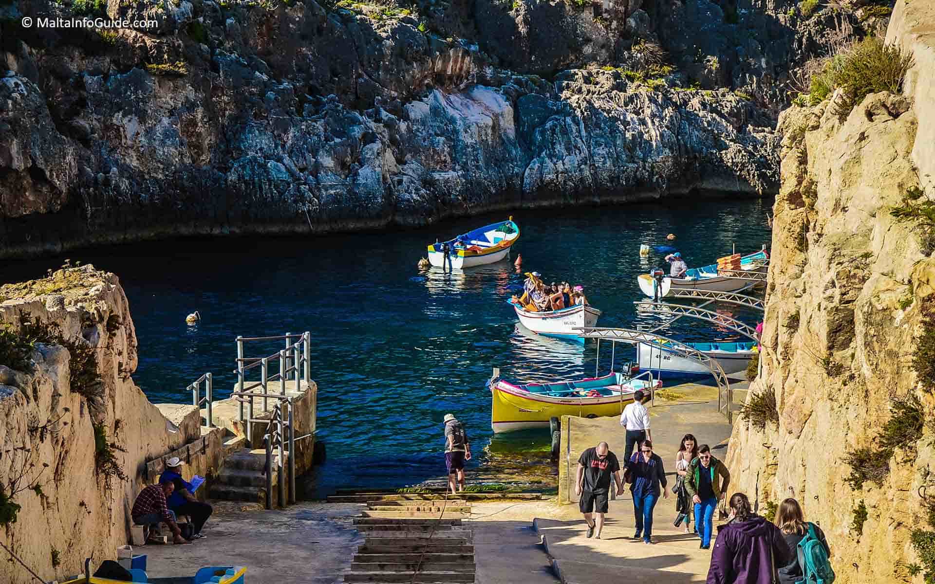 People walking up the hill after the boat trip to the caves.