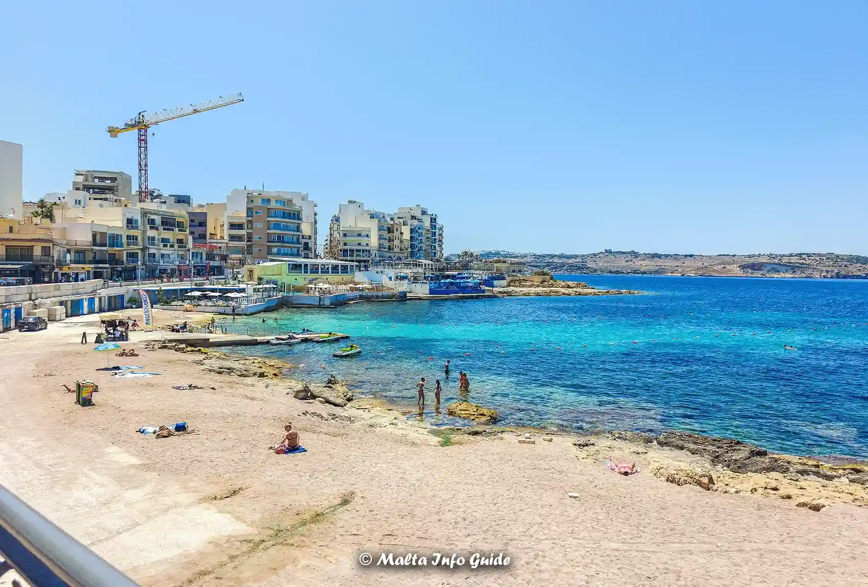 Wide view of Bugibba Perched Beach and seafront.