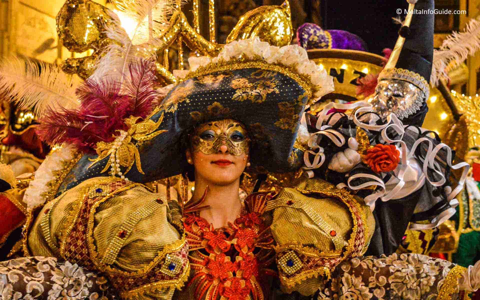 A lady dressed up in a gold and orange costume during Carnival in Malta