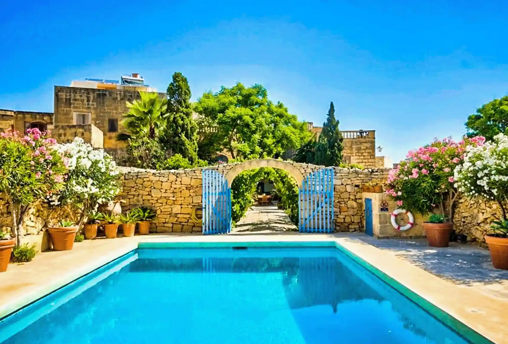 Casa Mezzodì Farmhouse, Kerċem, Gozo, Malta, private pool courtyard, lush garden, traditional stone walls.