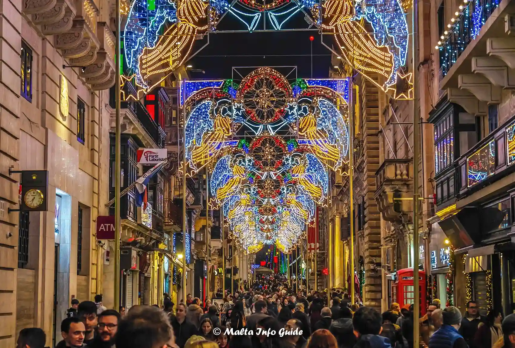 Republic Street in Valletta packed with people during the festive season in December. Christmas decorations in Valletta Malta.