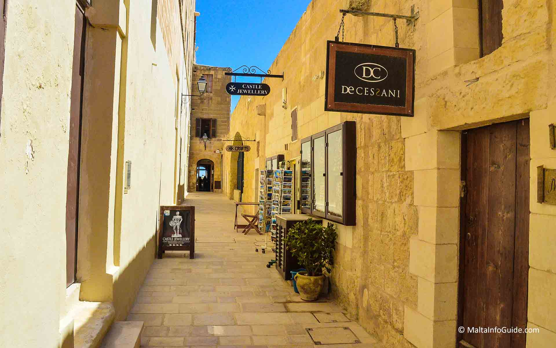 Shops on the right side of a narrow pathway at Citadel Malta