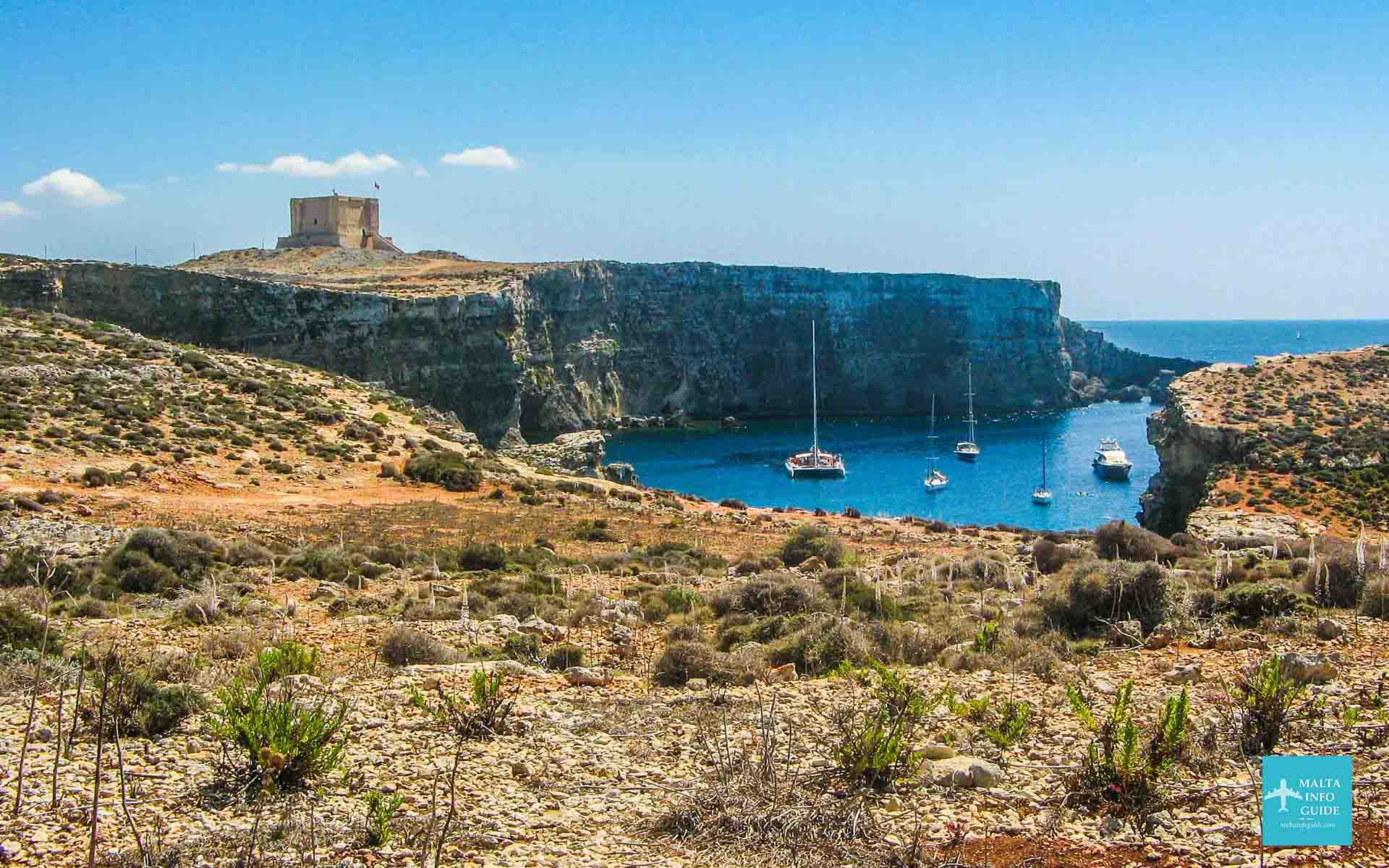 A view of the island of Comino Malta with Santa Marija Tower in the background.
