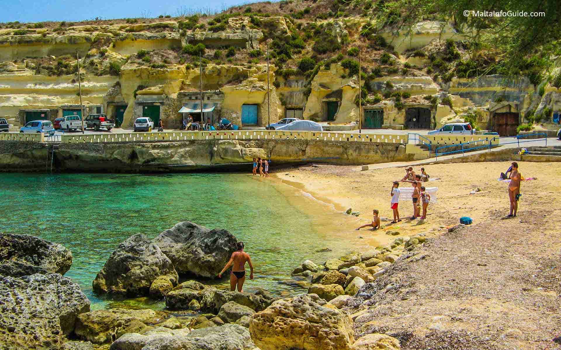 People on the sand at Dahlet Qorrot bay Gozo