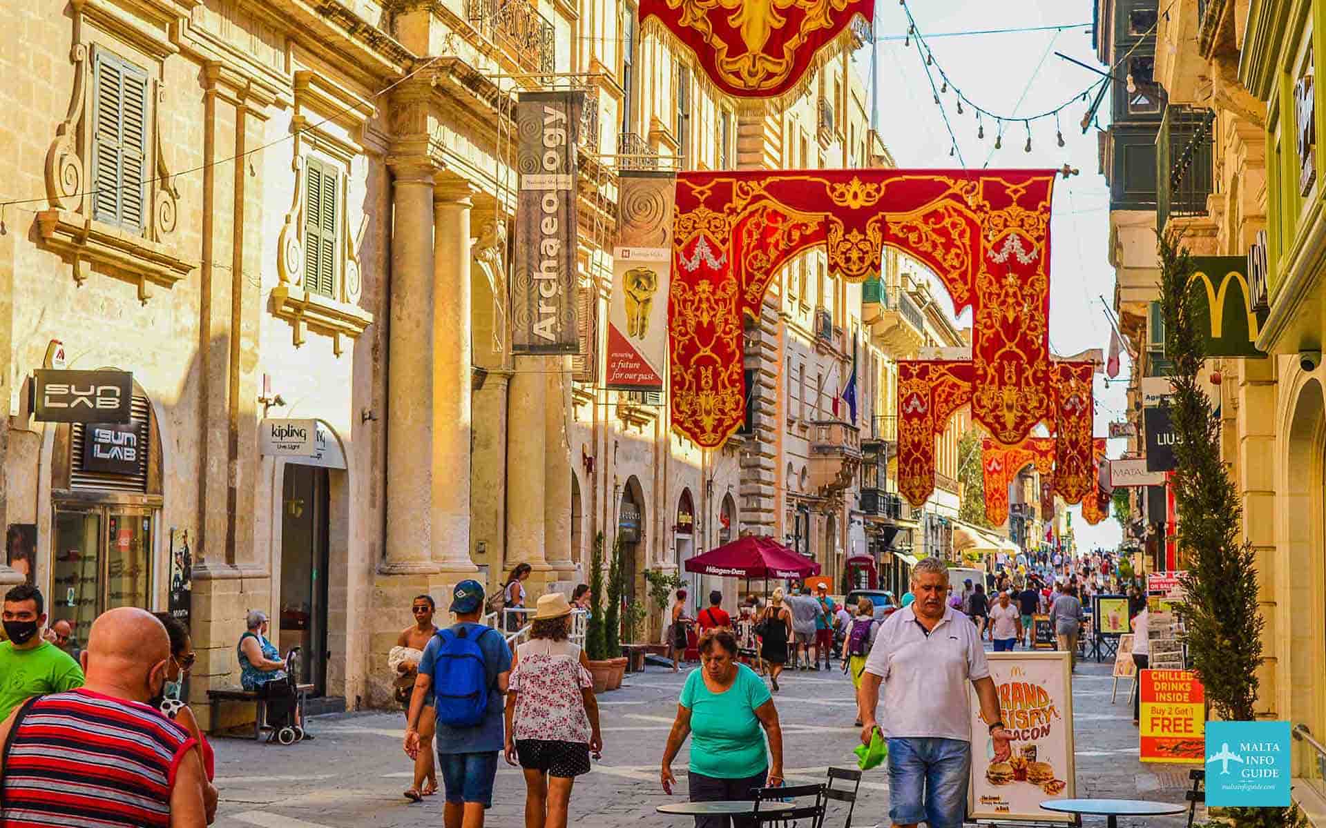 People walking in republic street with the street decorated the feast.