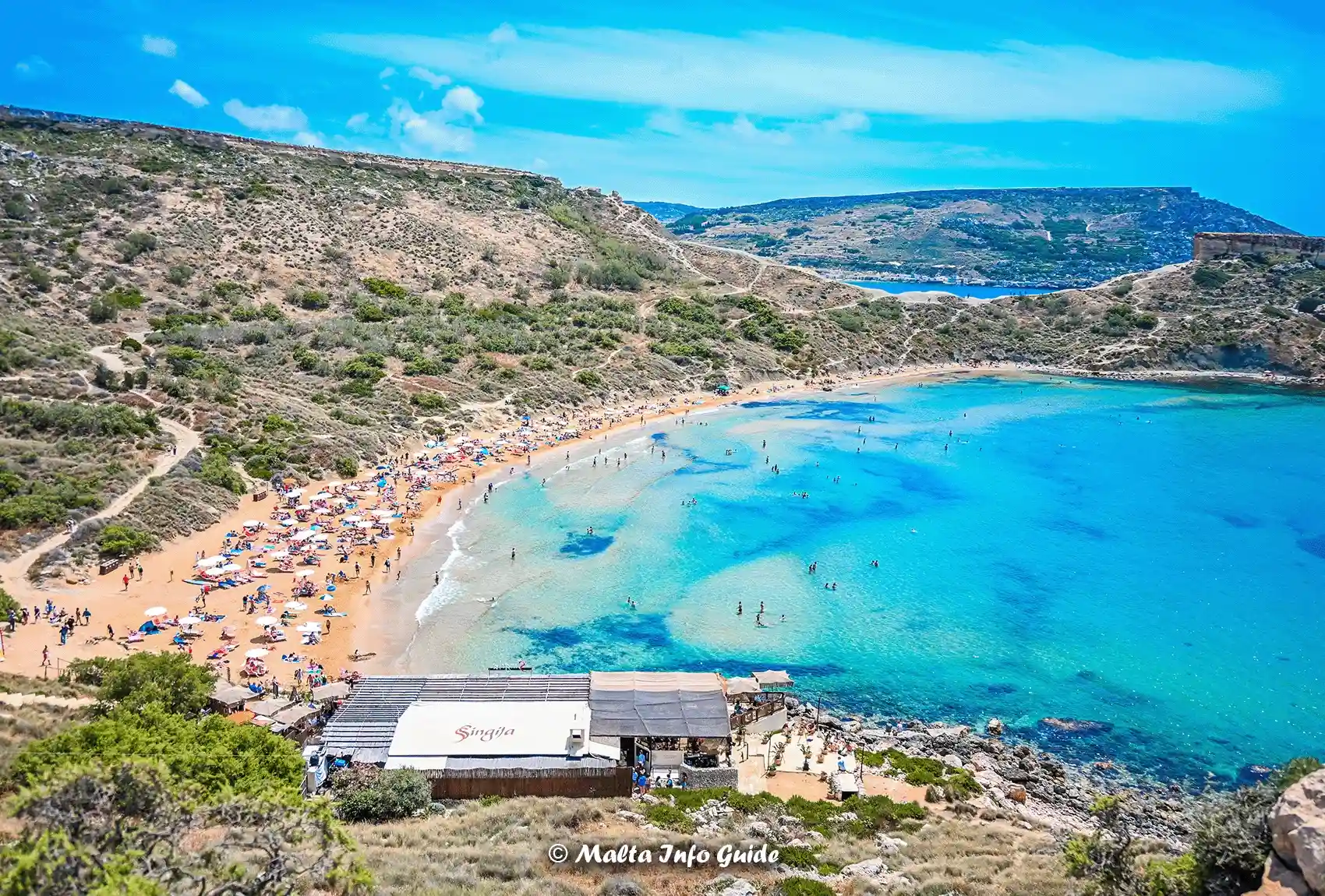 Għajn Tuffieħa Bay beside turquoise water.