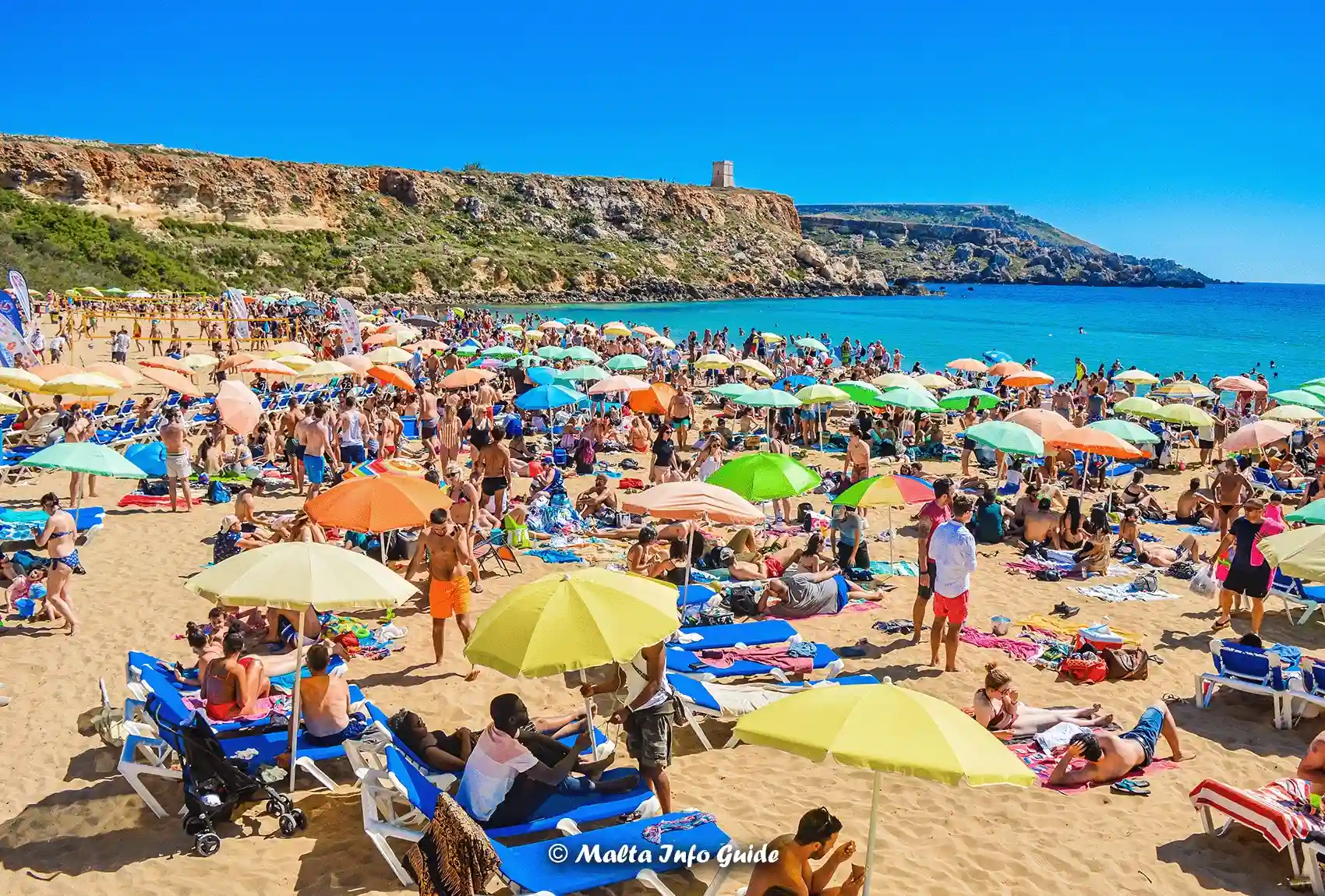 Crowded Golden Bay beach filled with summer visitors.