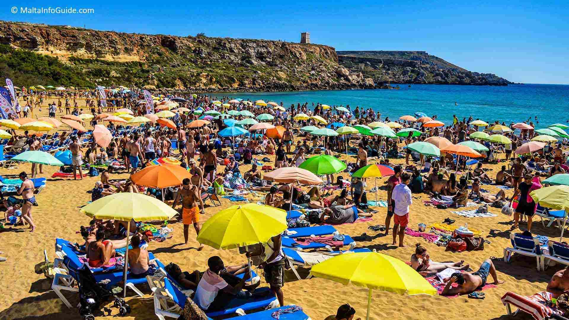 People sunbathing at Golden Bay Malta.