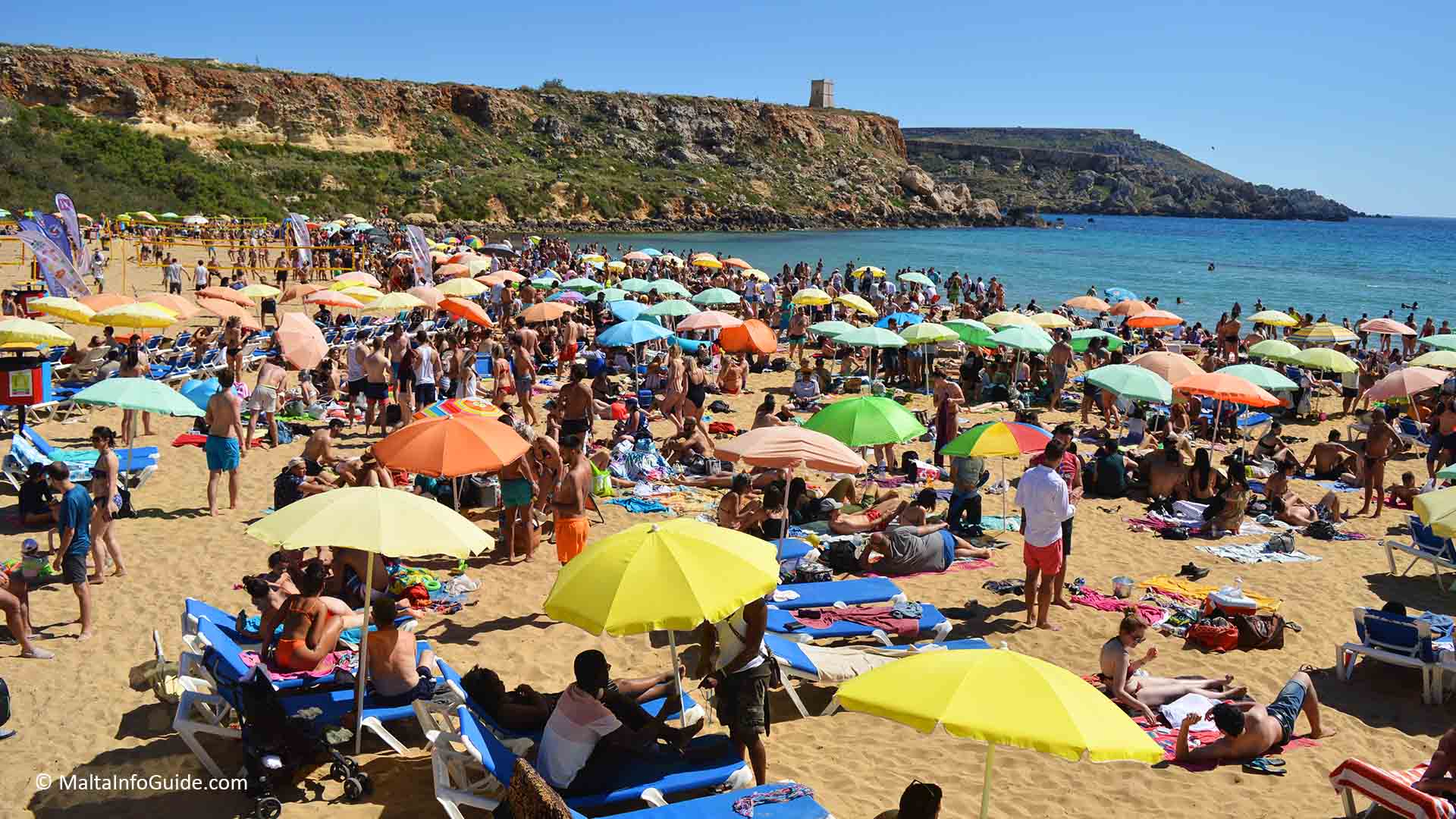 People sunbathing at Golden Bay. One of Malta's Blue flag beaches.