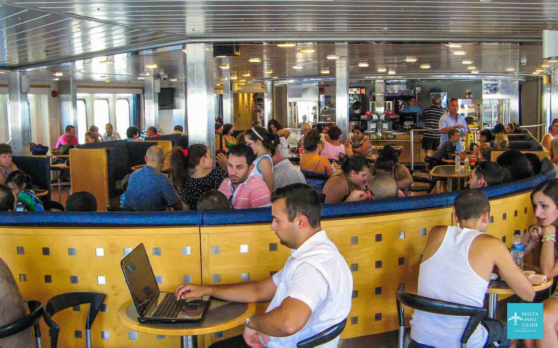 People sitting down inside the Gozo ferry boat en-route to Gozo.