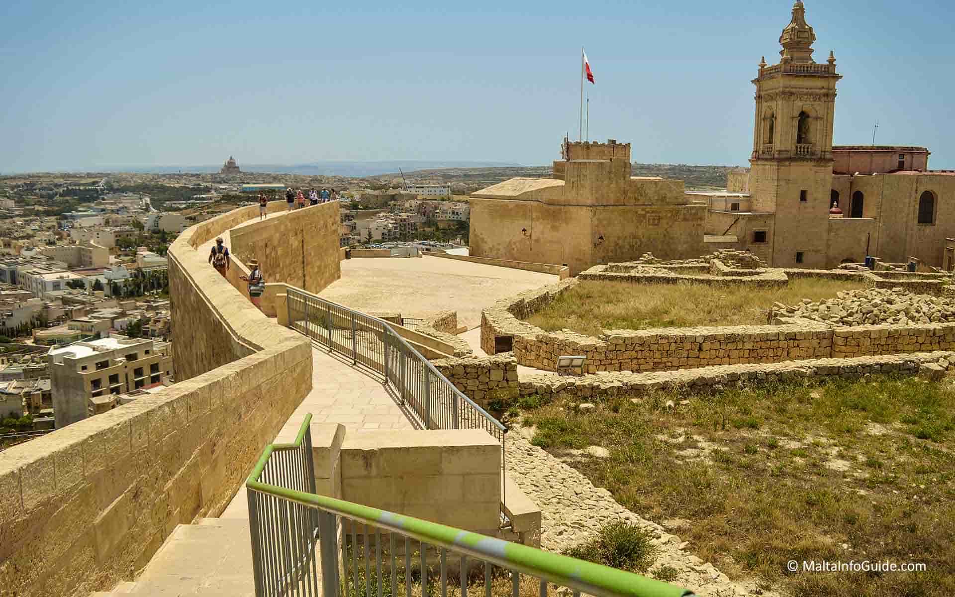 People walking on the rear of the citadel on the fortifications path People walking on the rear of the citadel on the fortifications path
