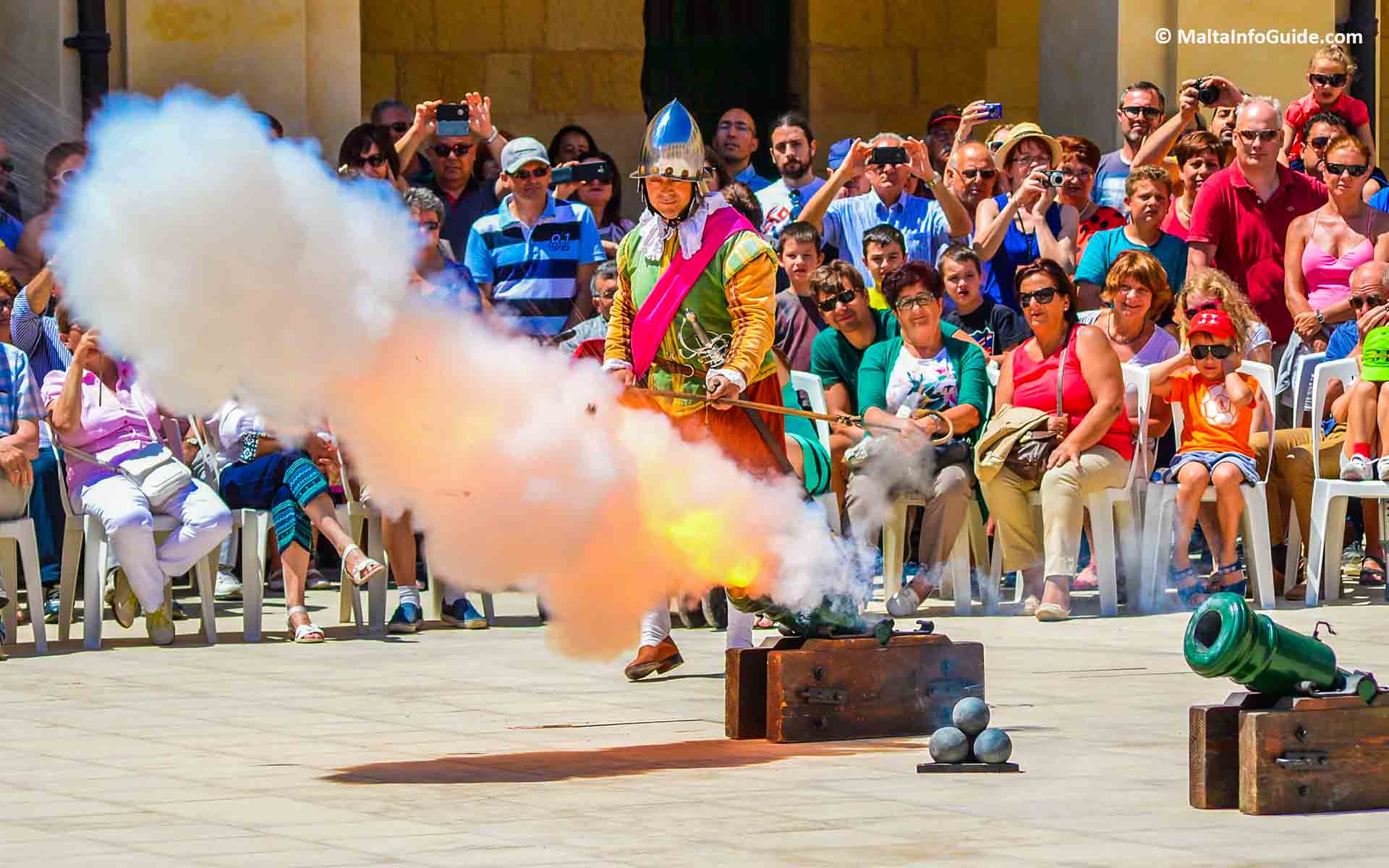 A small cannon being fired during the parade. A small cannon being fired during the parade.