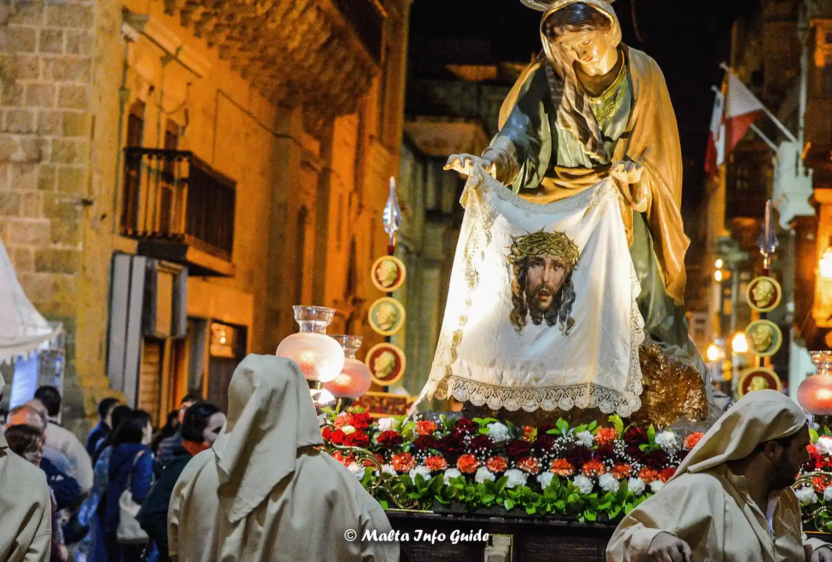 People holding the statue which shows the stage where a woman named Veronica wiped the face of Jesus with her veil. A Good Friday Statue during the procession in Valletta Malta.