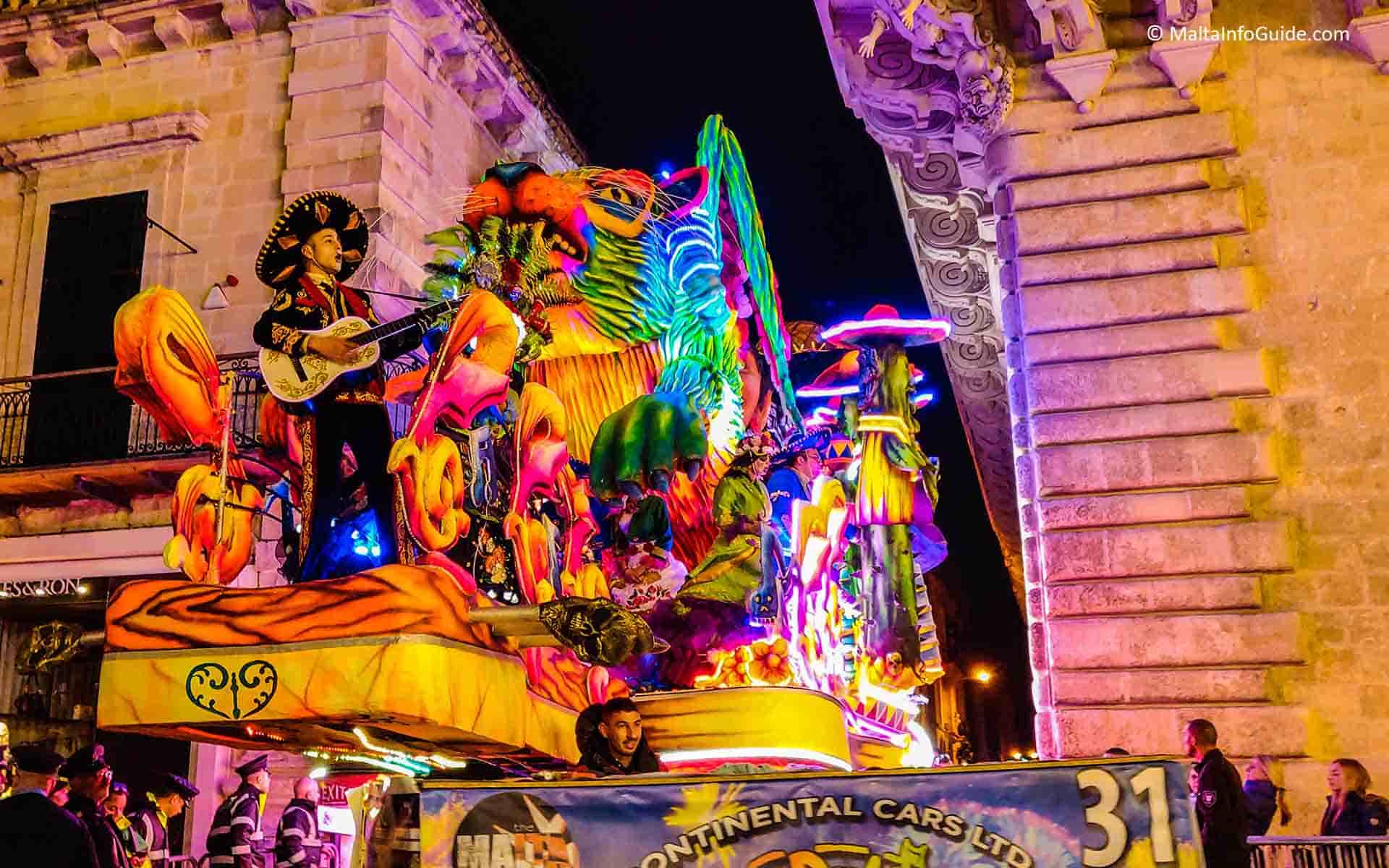 A participant playing the guitar on a carnival float in Malta