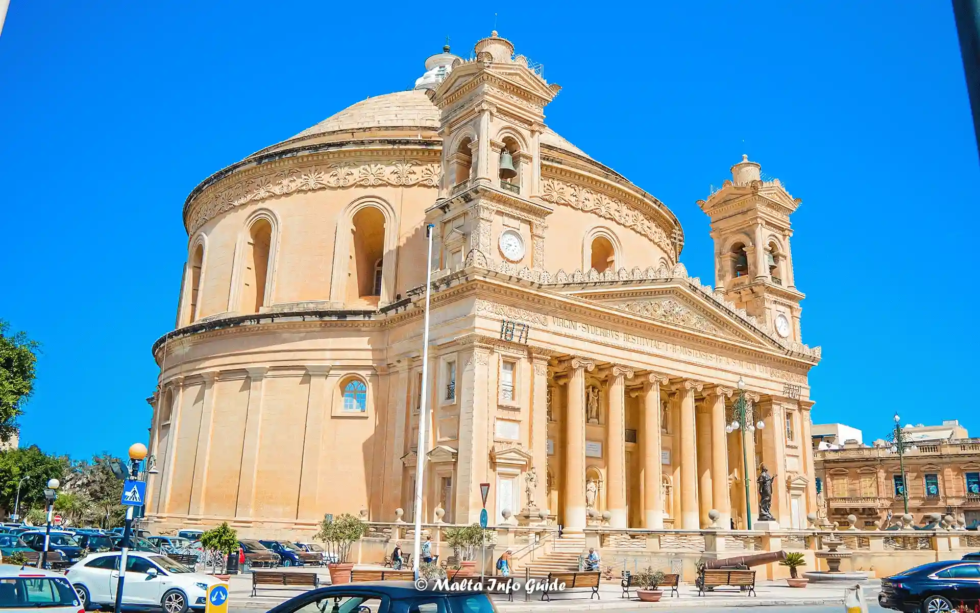 The magnificent Mosta Rotunda in Malta against a deep blue sky.