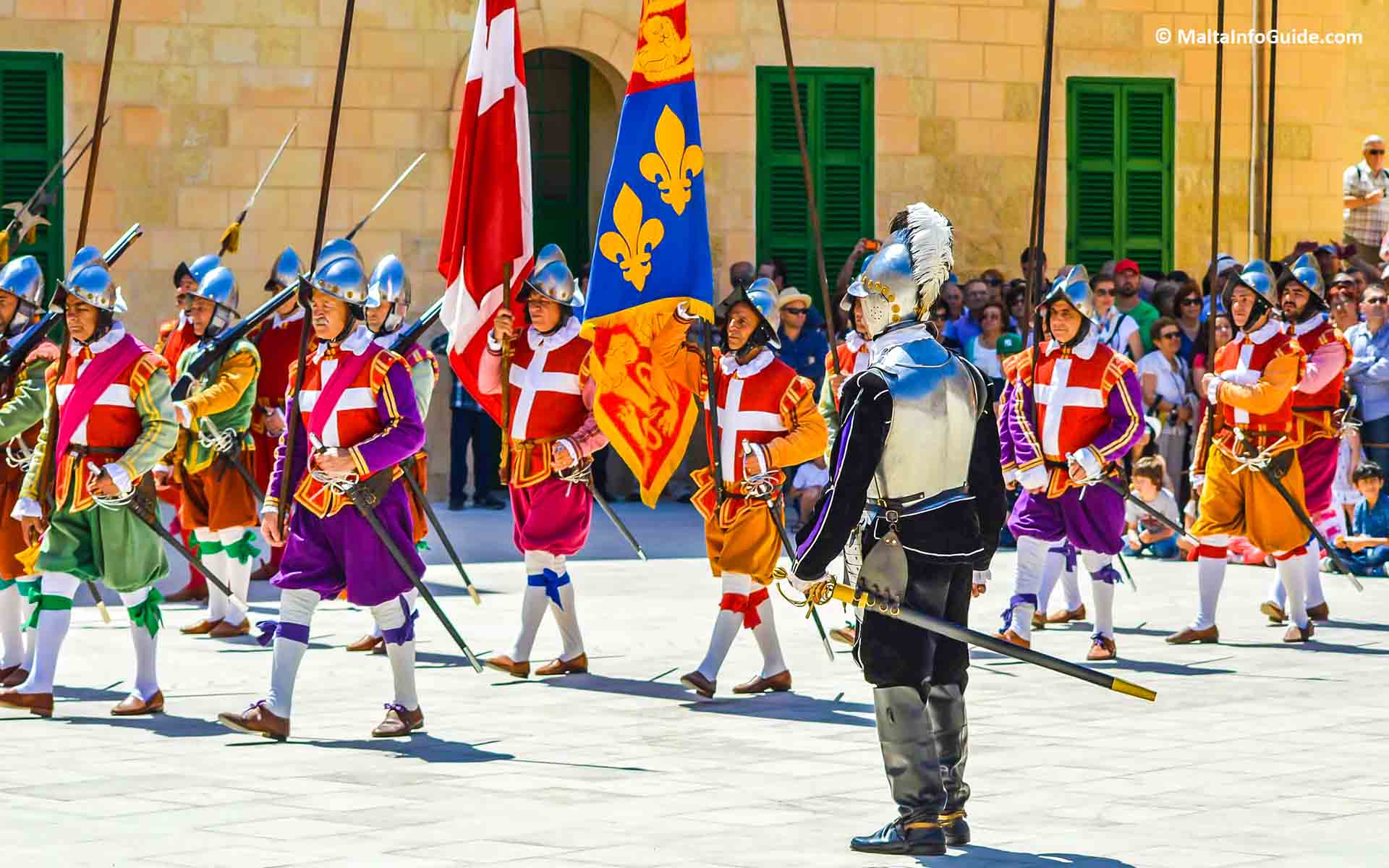 People dressed as knights re-enacting a march. People dressed as knights re-enacting a march.