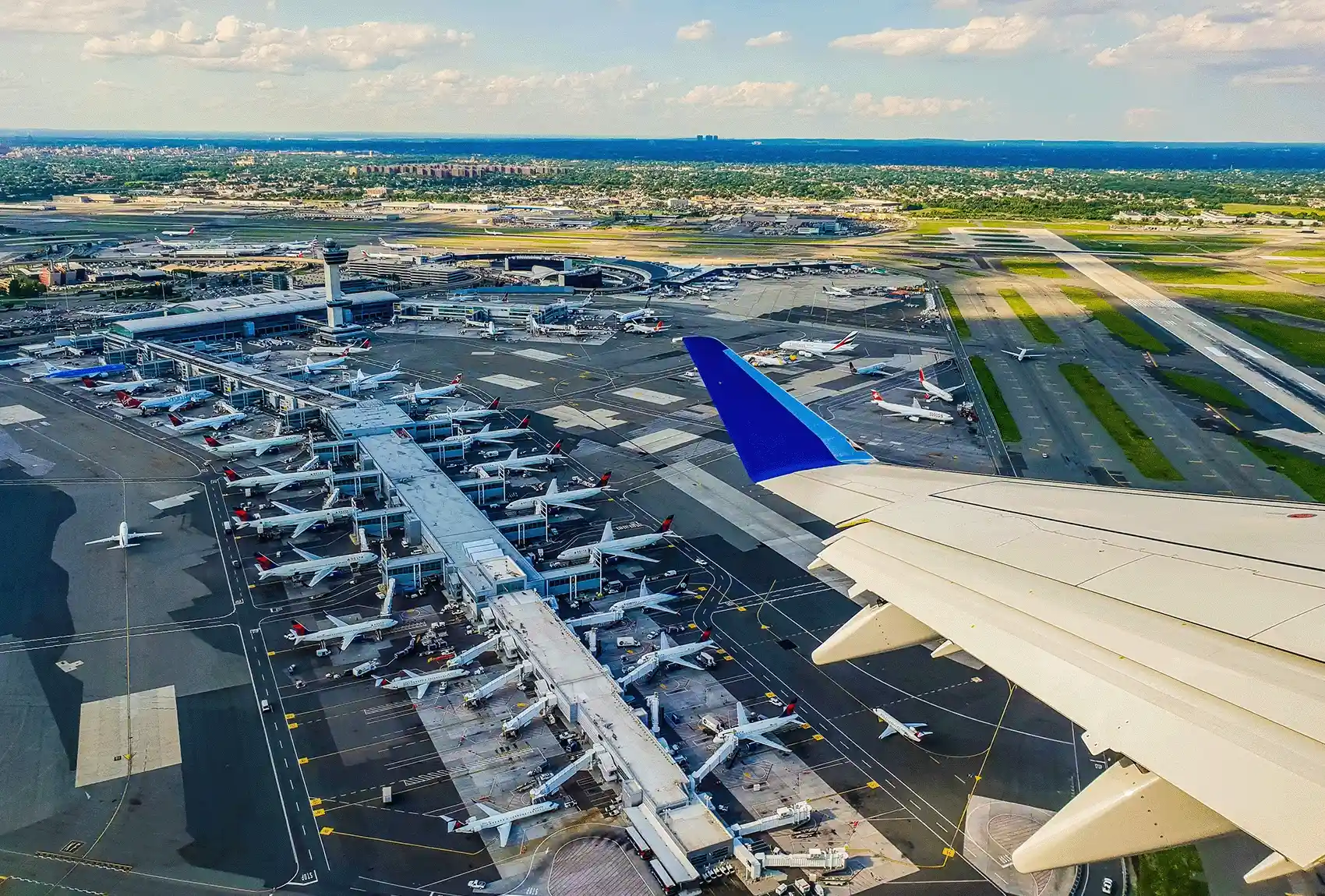 Aerial view of aircraft and terminals at New York JFK Airport.
