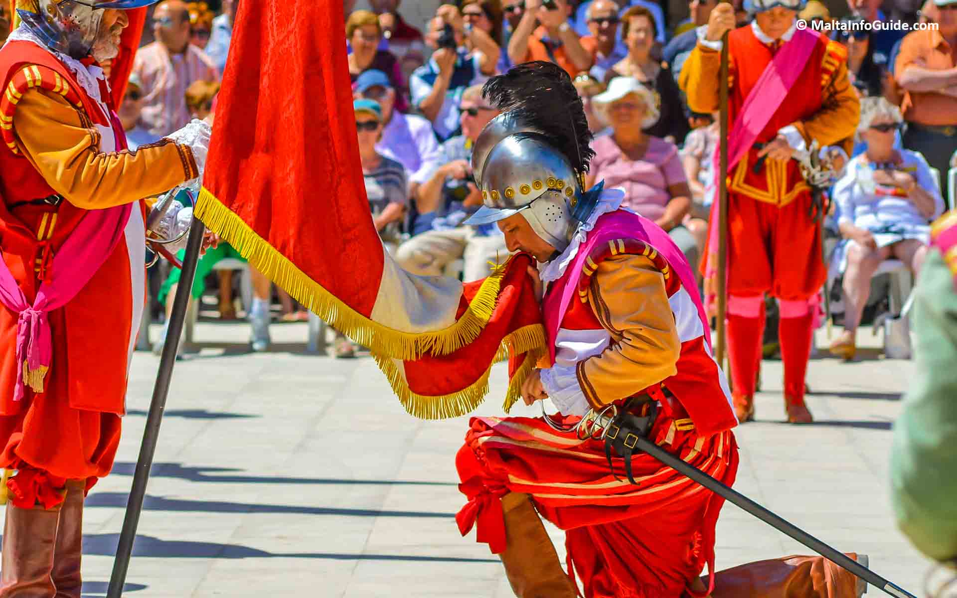 A man on his knees kissing a flag. A man on his knees kissing a flag.
