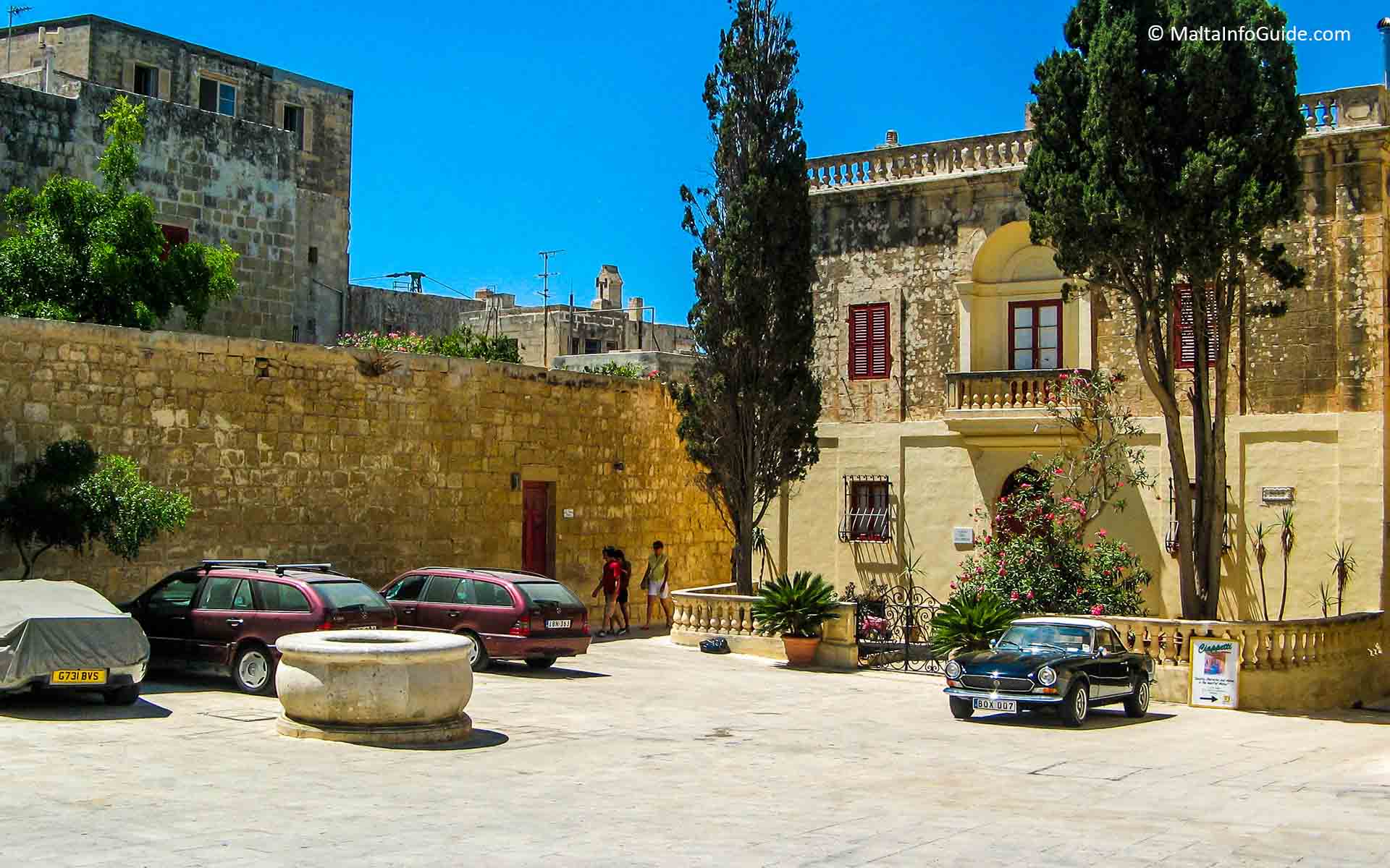Cars parked in a small square in Mdina