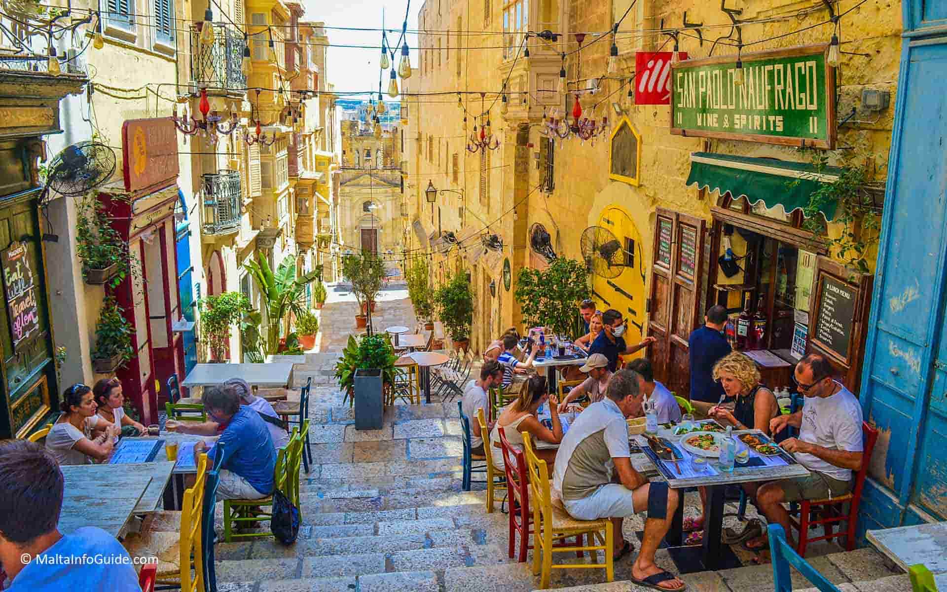 People eating at a restaurant at one of Valletta's most beautiful streets.