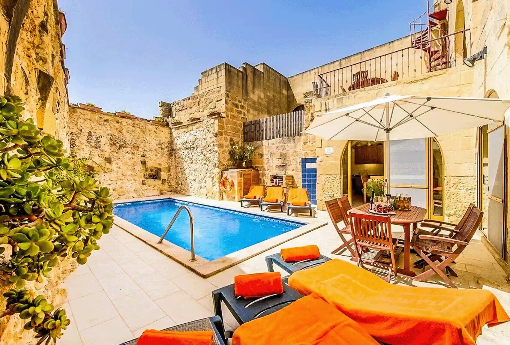 Lellux Holiday Home, Nadur, Gozo, Malta, private pool, courtyard with outdoor dining and sunny relaxation space.