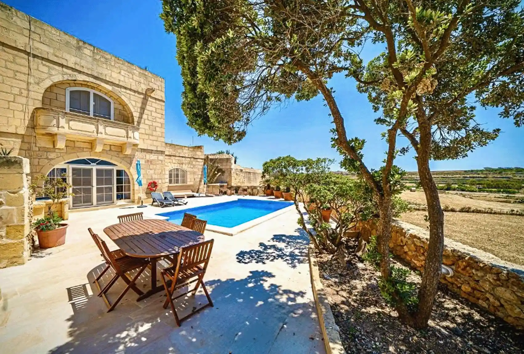 Lonza Farmhouse, Għarb, Gozo, Malta, private pool terrace with countryside views in a traditional limestone setting.