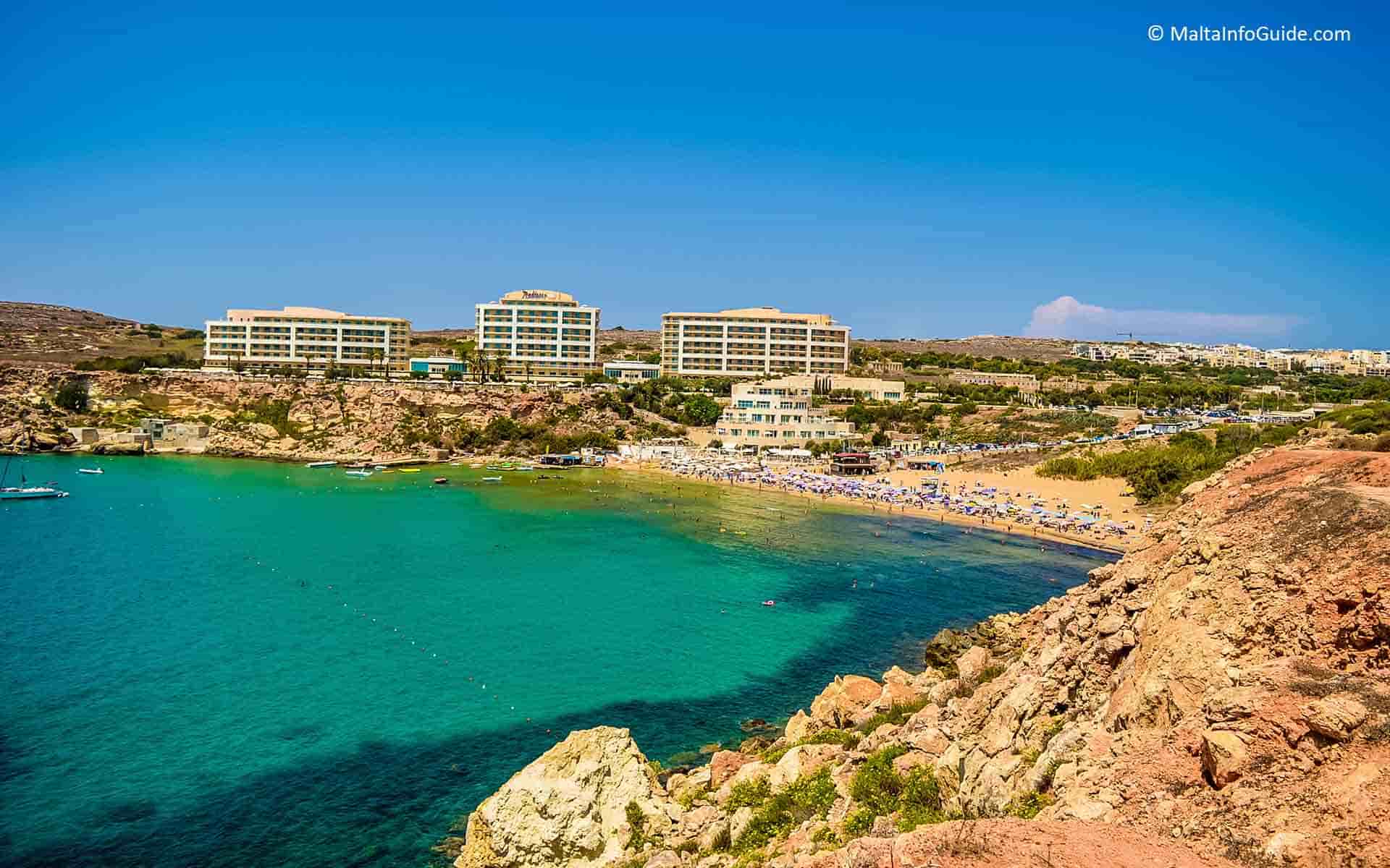 Golden Bay hotel and beach from the top of a cliff.