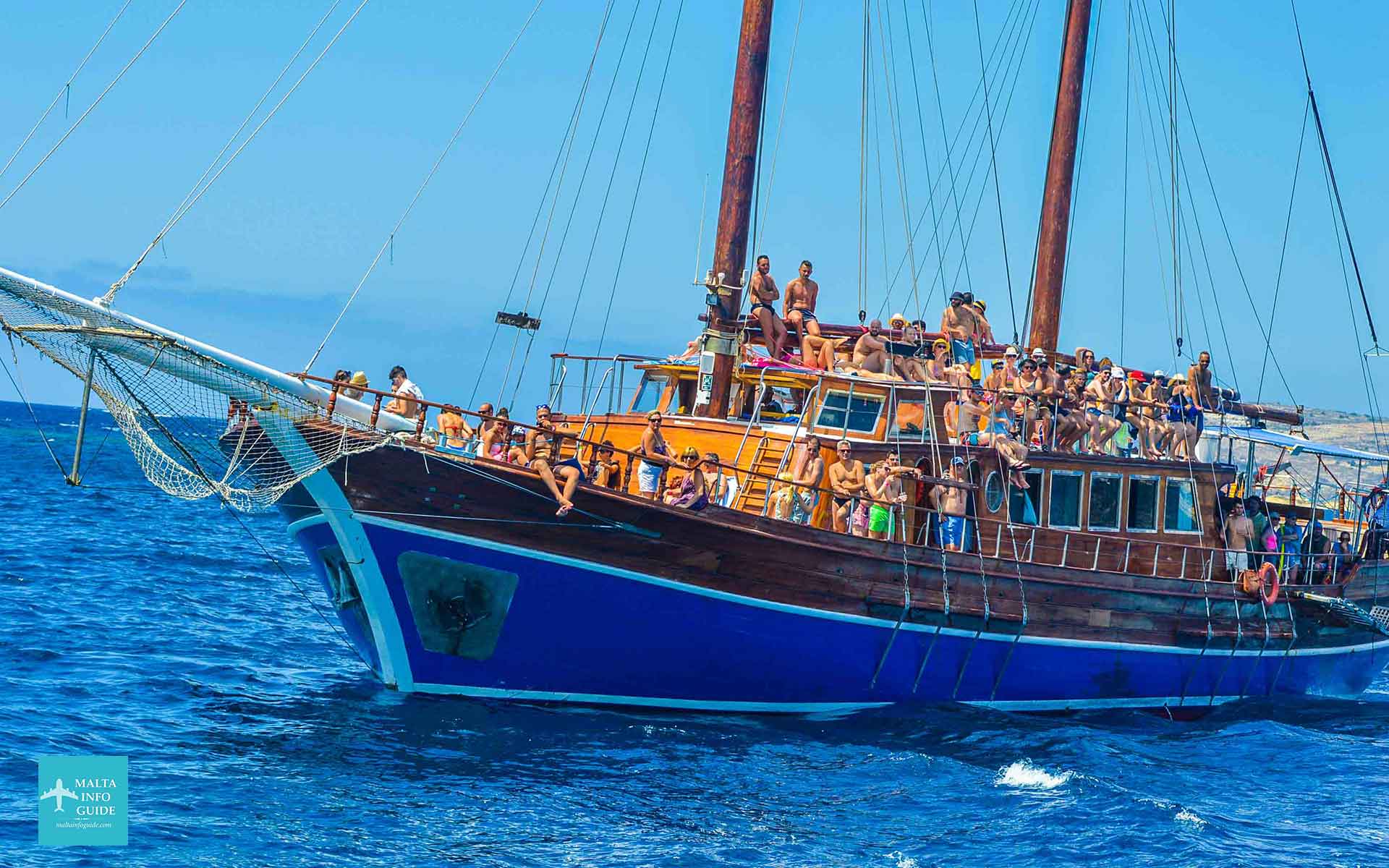 People sitting on the Fernandes Boat while sailing to Comino.