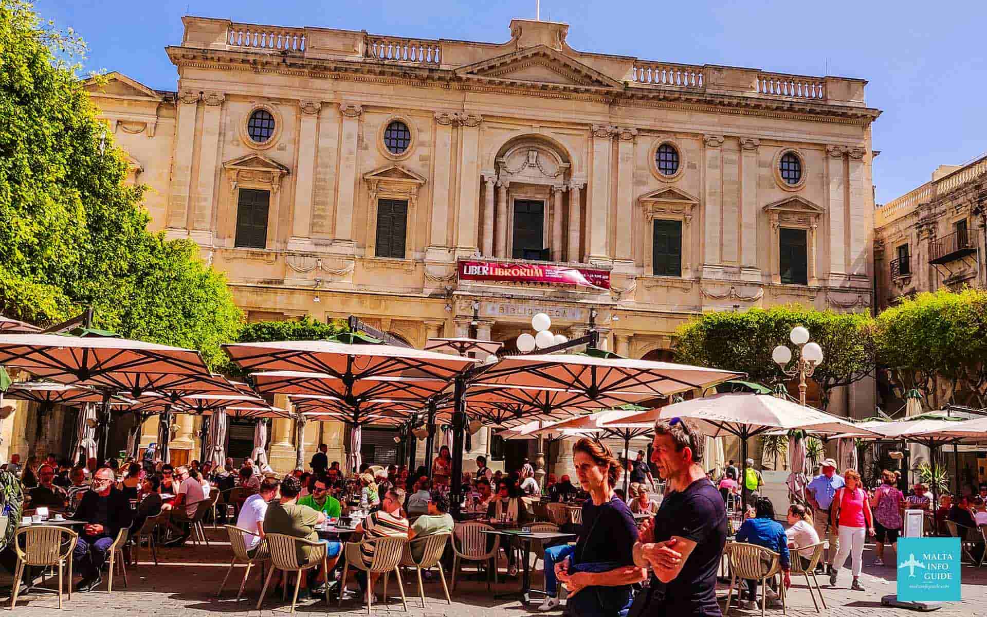 People eating at table at Republic Square Valletta. People eating at table at Republic Square Valletta.