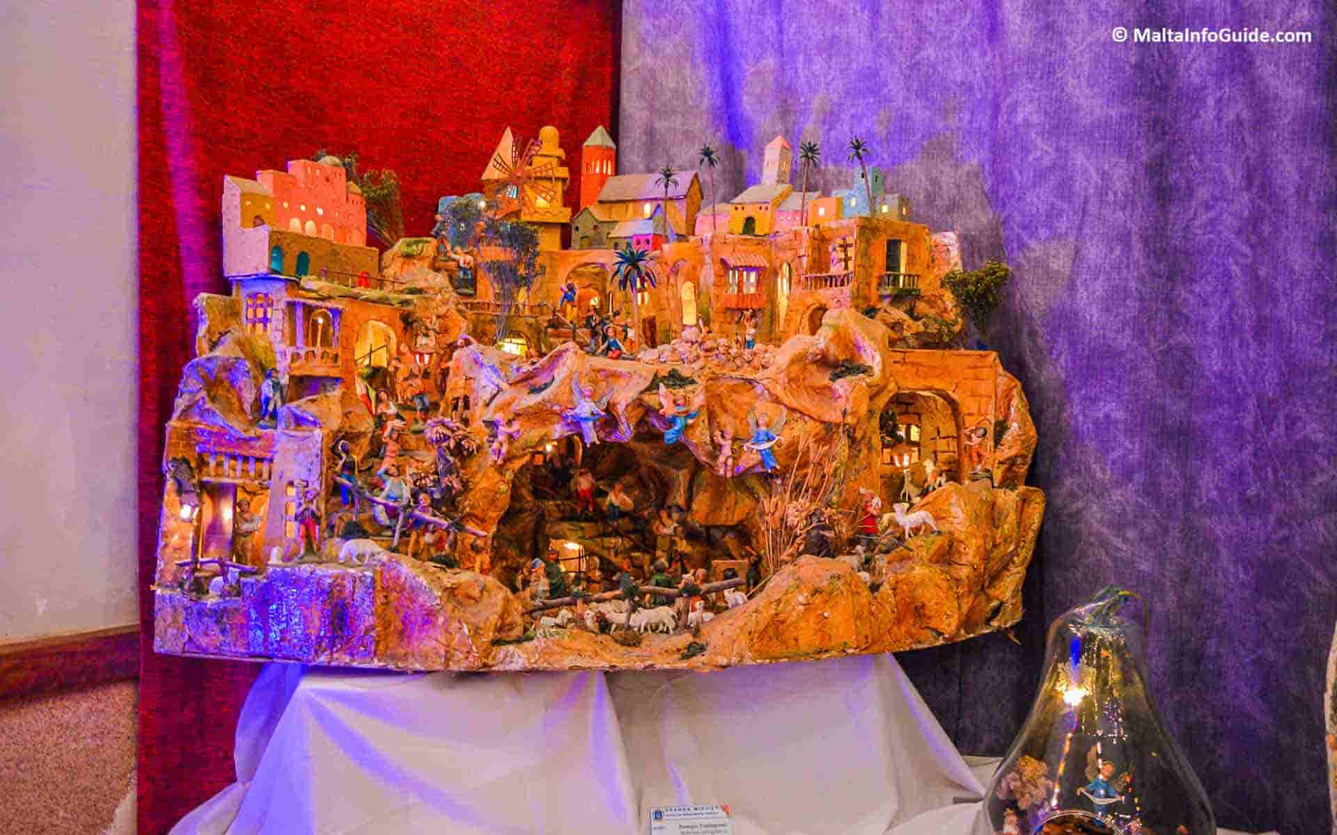 A wonderful paper mache crib that features elaborate craftsmanship and traditional Christmas crib on display. A beautiful paper mache crib displayed.