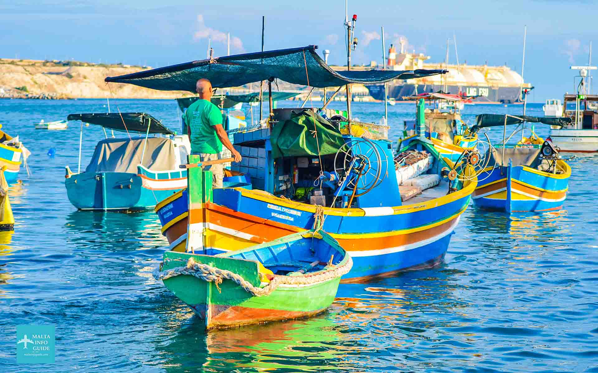 Maltese local on a traditional fishing boat in Marsaxlokk Malta