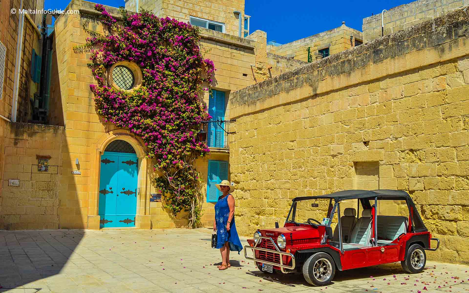 A woman posing in front of an iconic Instagramic place in Mdina.