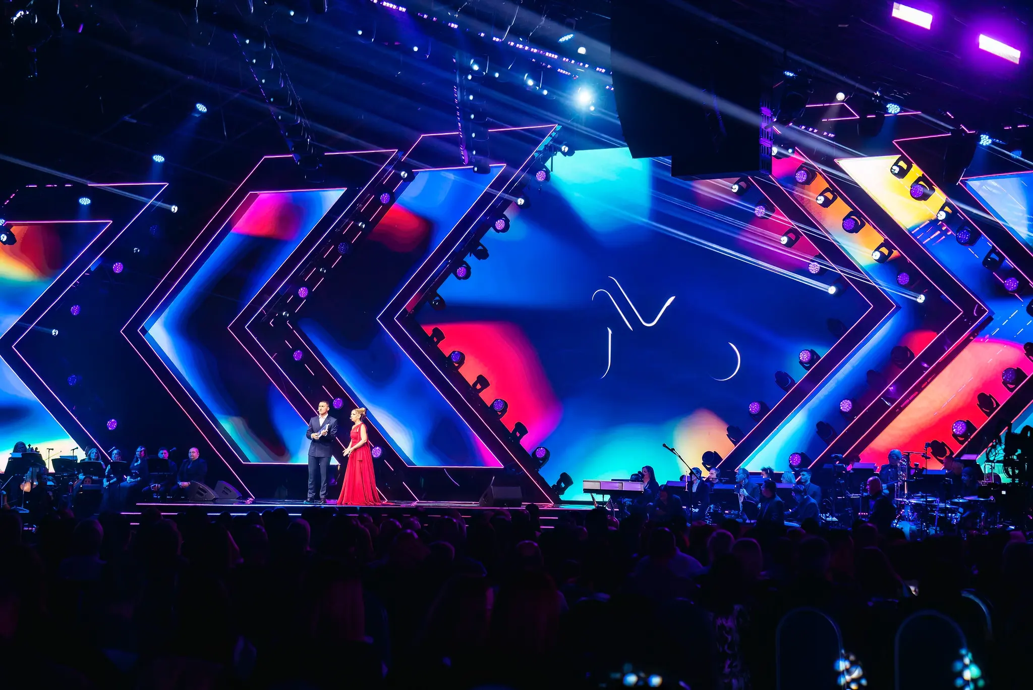 Presenters on a colourful stage during Muzika Muzika.