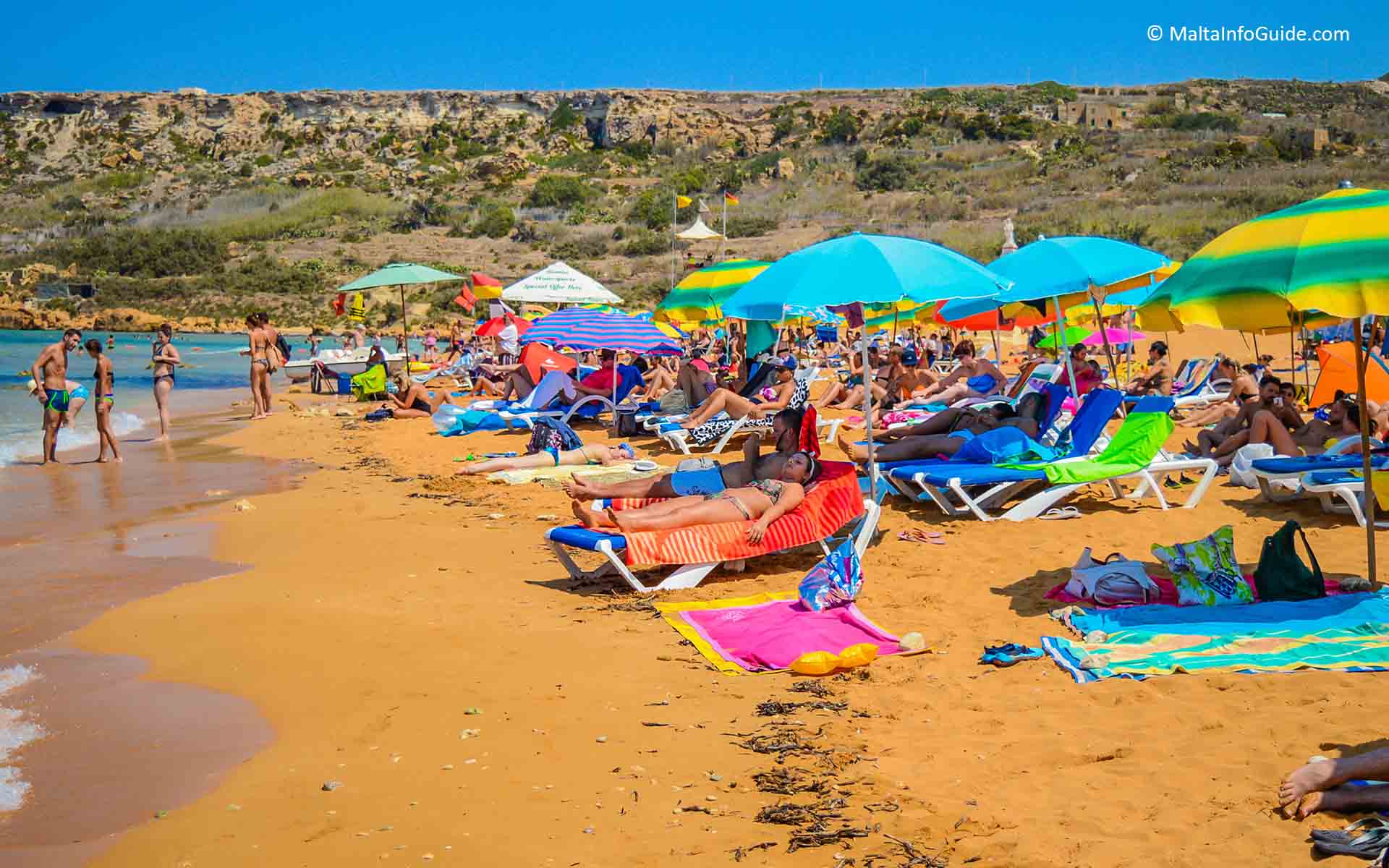 People sunbathing at Ramla Bay Gozo