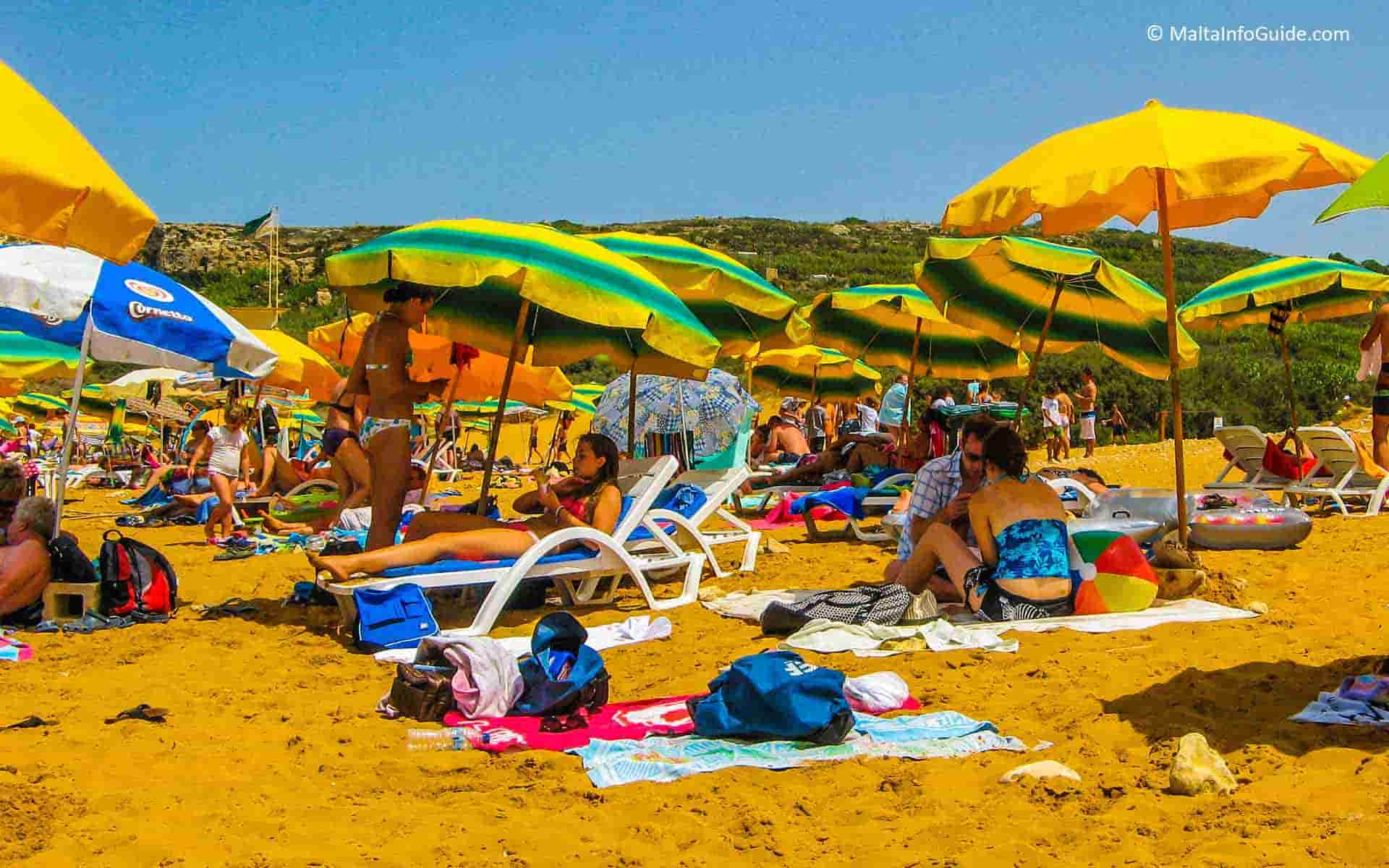 People sunbathing at Ramla Bay Gozo.