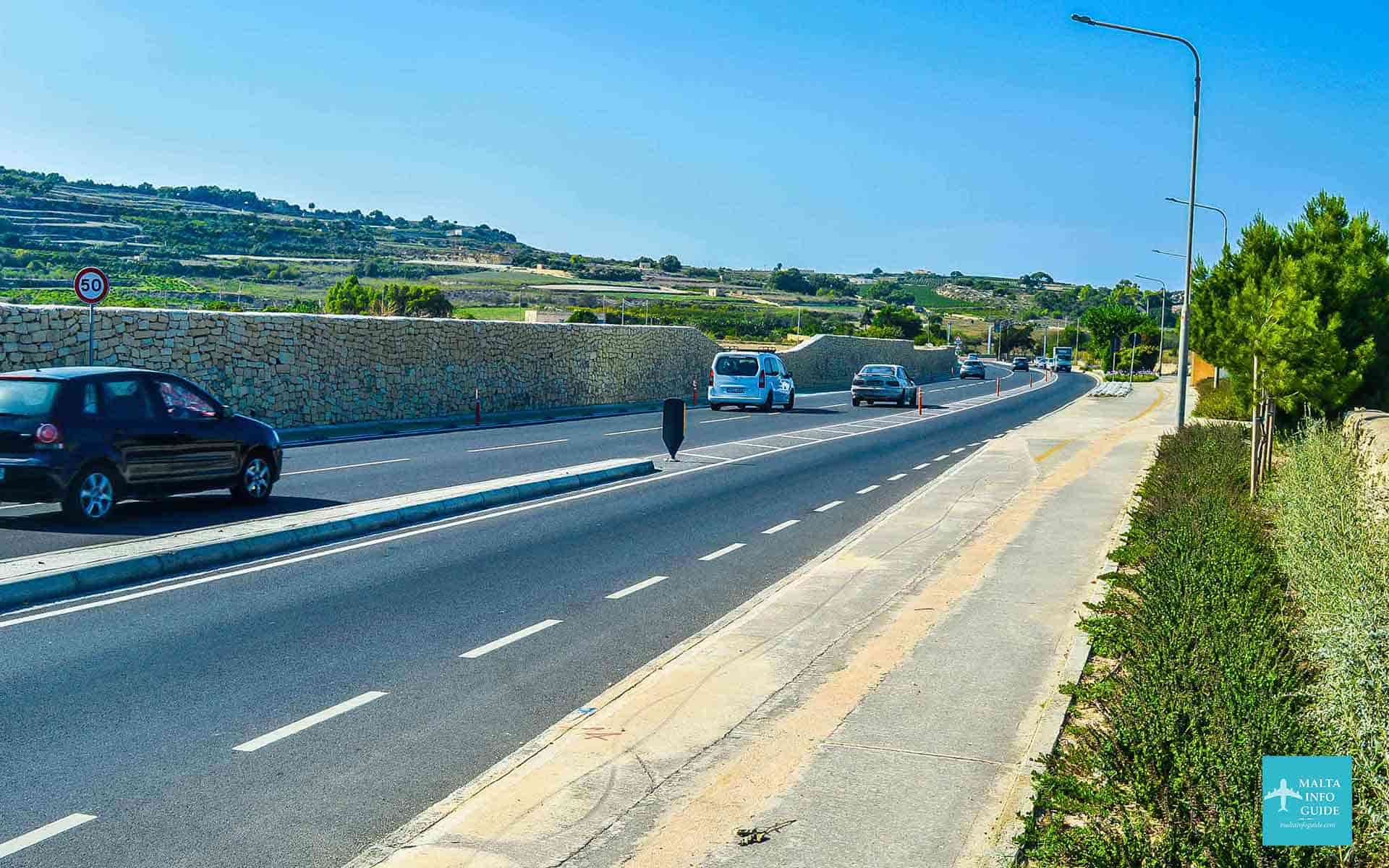 Cars driving towards Mosta or other villages.