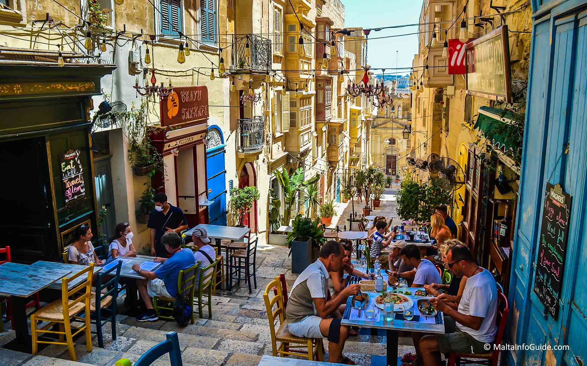 People eating at a restaurant in St. Lucy street Valletta.