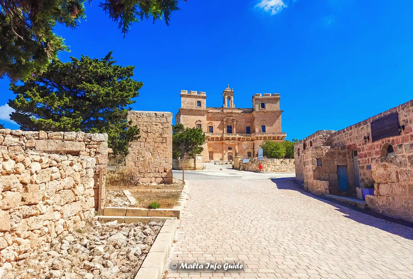 Historic Selmun Palace is surrounded by traditional limestone buildings close to the village of Mellieħa.