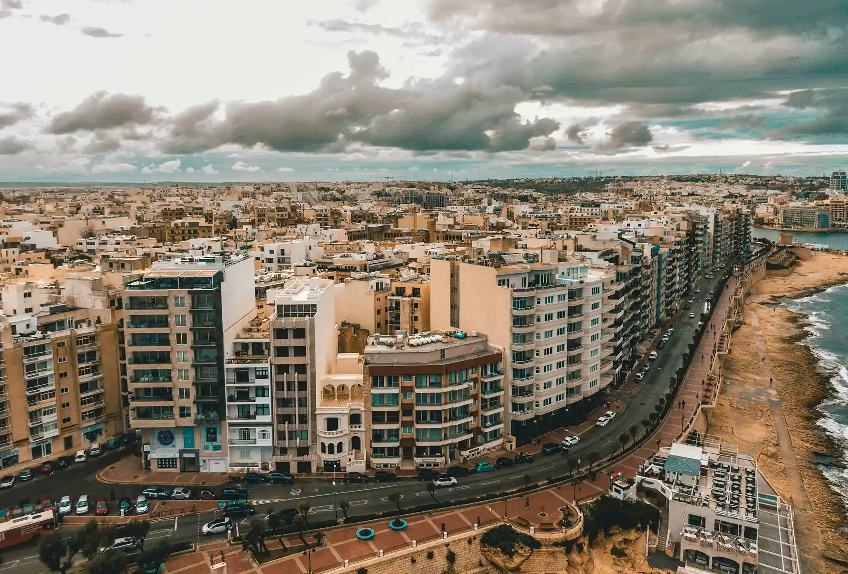 Wide coastal road running through built-up Sliema area.