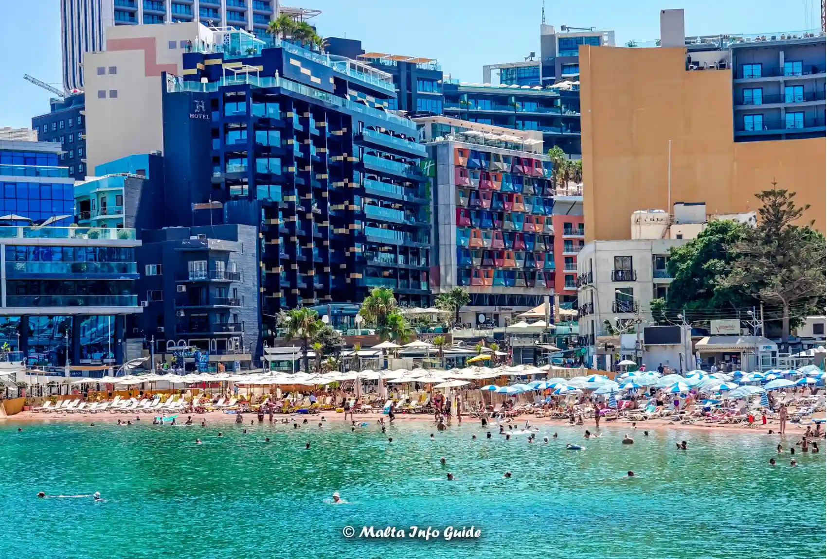 Swimmers in St George's Bay below surrounding hotels.