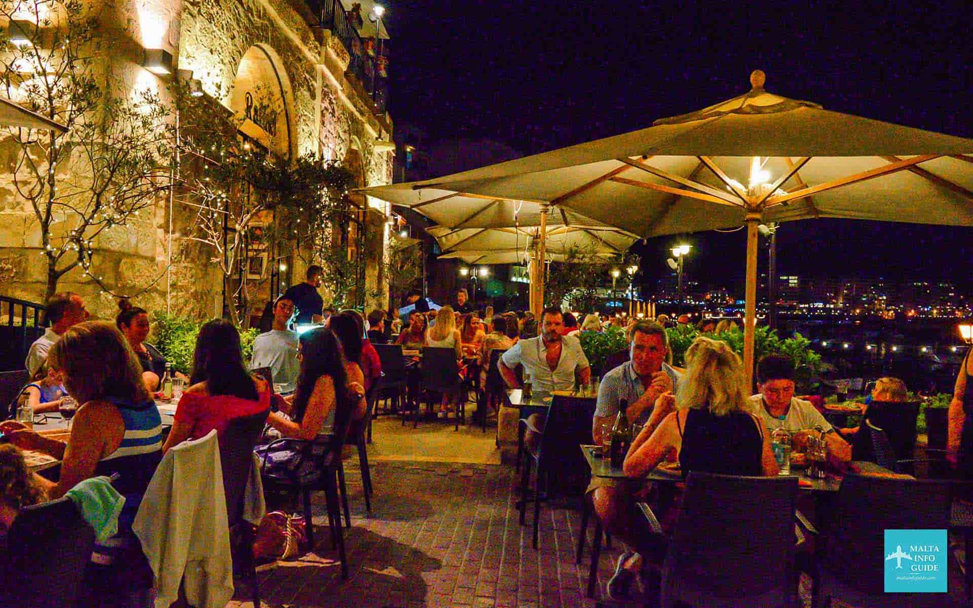 People eating dinner at a restaurant in St. Julian's Malta.