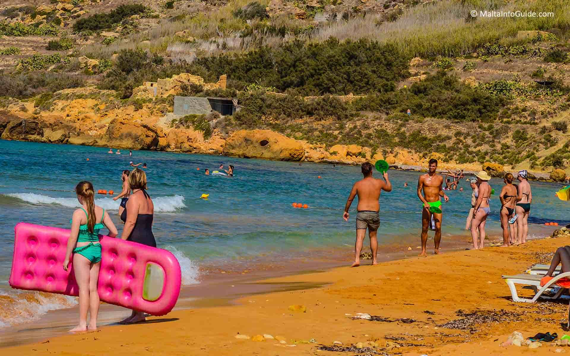 People playing sports at Ramla Il-Hamra Beach