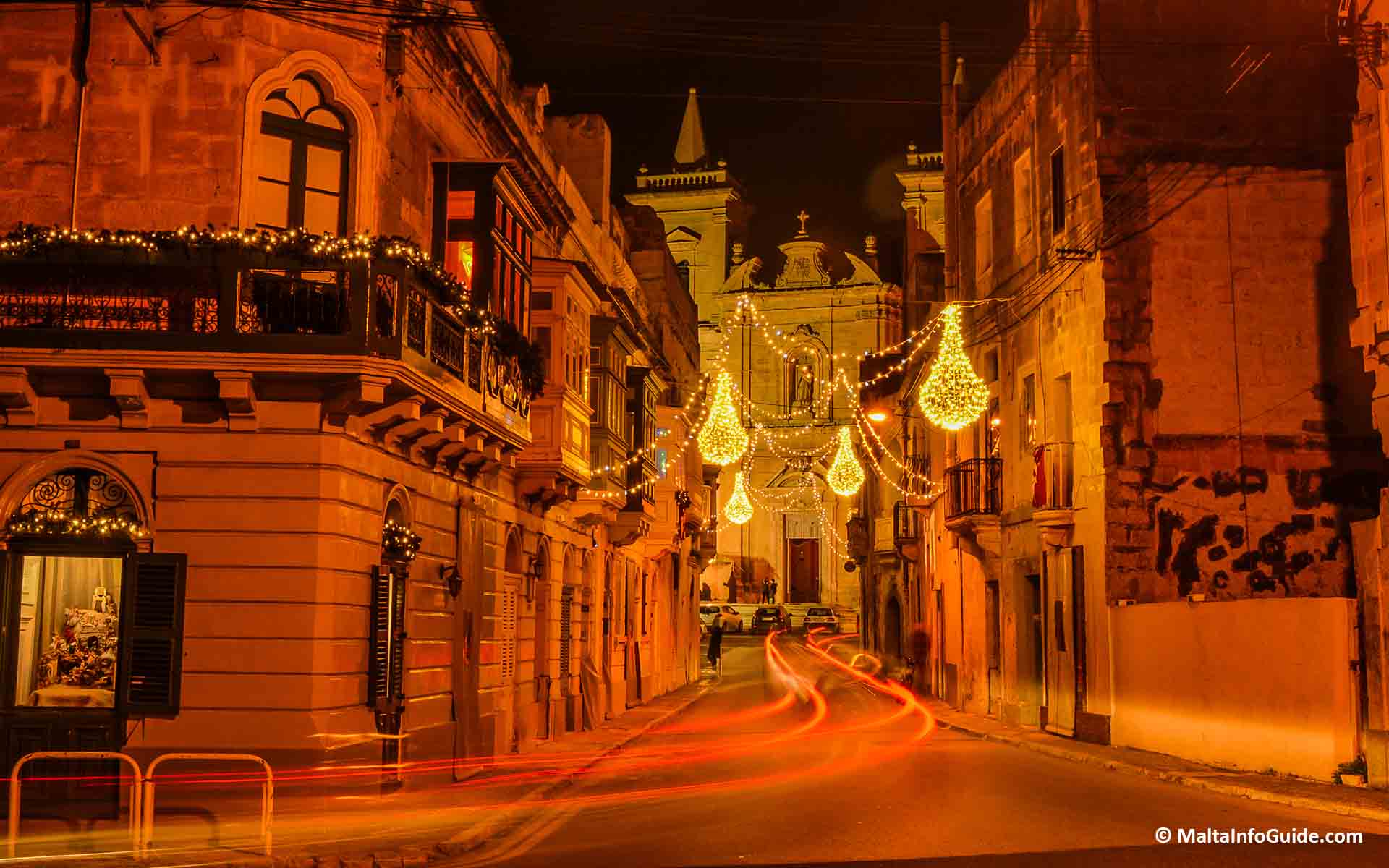 A street leading up to the parish church of Traxien decorated with Christmas lights.