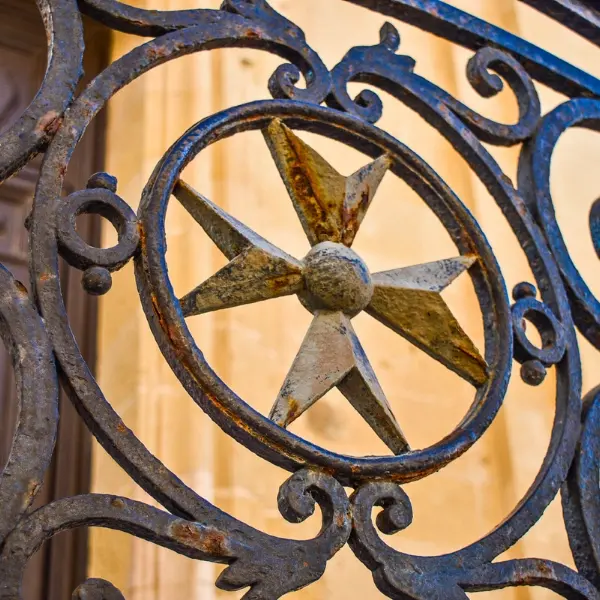 The 8 Pointed Cross on a railing in Valletta.