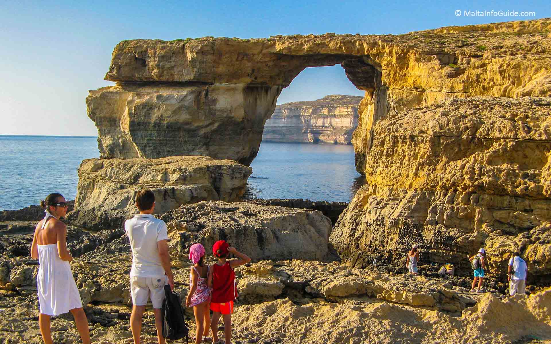 A family looking at the Azure Window 5 years before its collapse.