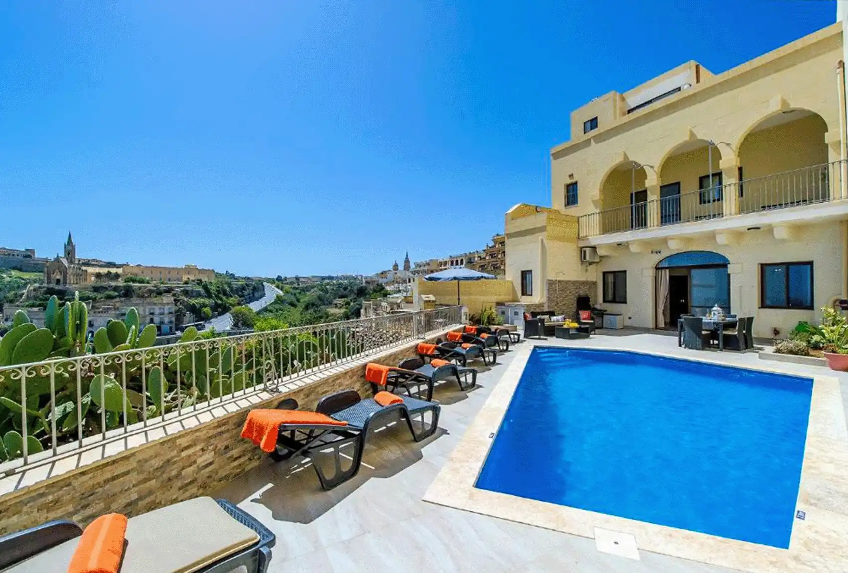 The Harbour Holiday Home Gozo's pool terrace with countryside views in Gozo, Malta.